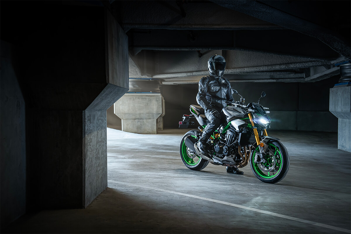 Profile angle of a rider on a motorcycle in a parking garage.