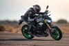 Profile angle of a rider leaning into a motorcycle on a track.