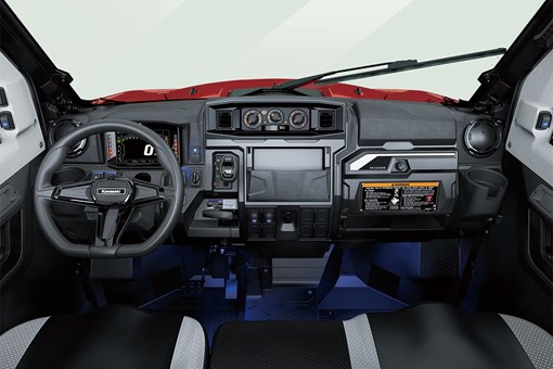 Interior cabin view of the front dash and controls of a side x side with floor accent lighting. opens in a new window