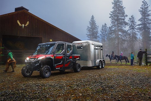 Three-quarter front angle of a side x side towing a horse trailer. opens in a new window