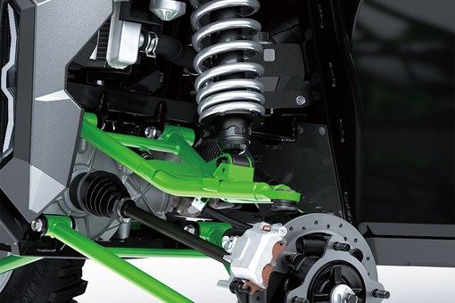 Detail view of front right A-arm, shock and brake rotor of a side x side. opens in a new window