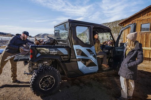 Side angle of two people loading a side x side. opens in a new window