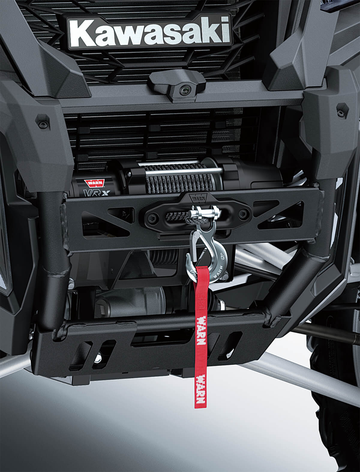 Detail view of the front bumper and winch of a side x side.