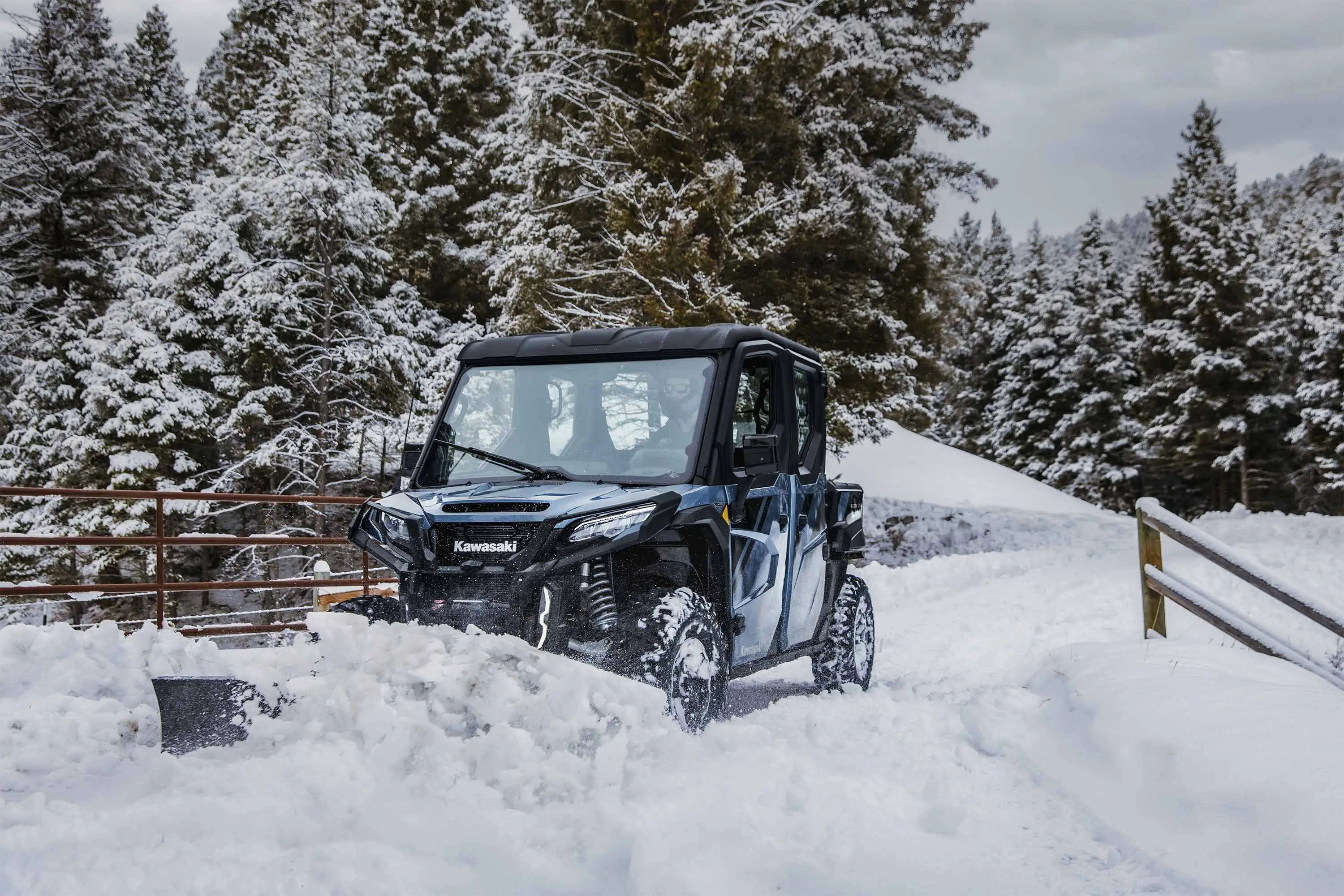 Front three-quarter angle of a side x side plowing snow.