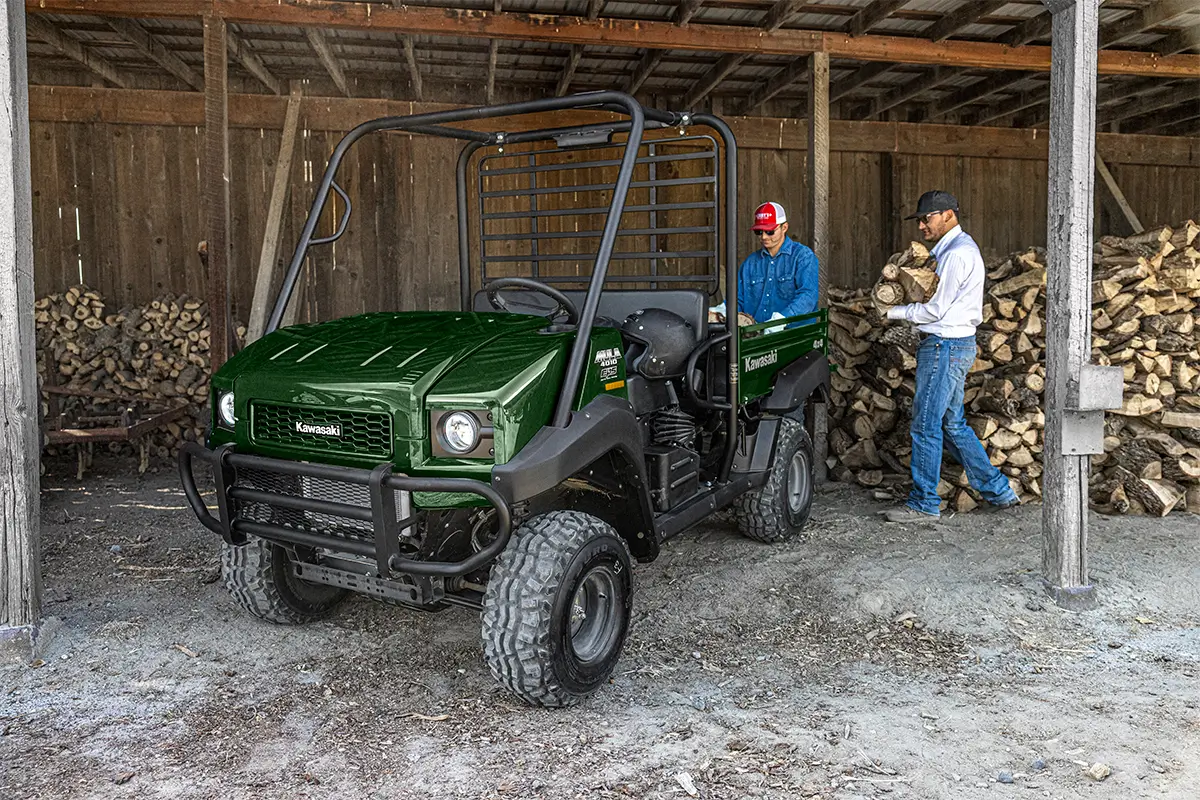 Three-quarter front angle of a side x side parked in a barn.