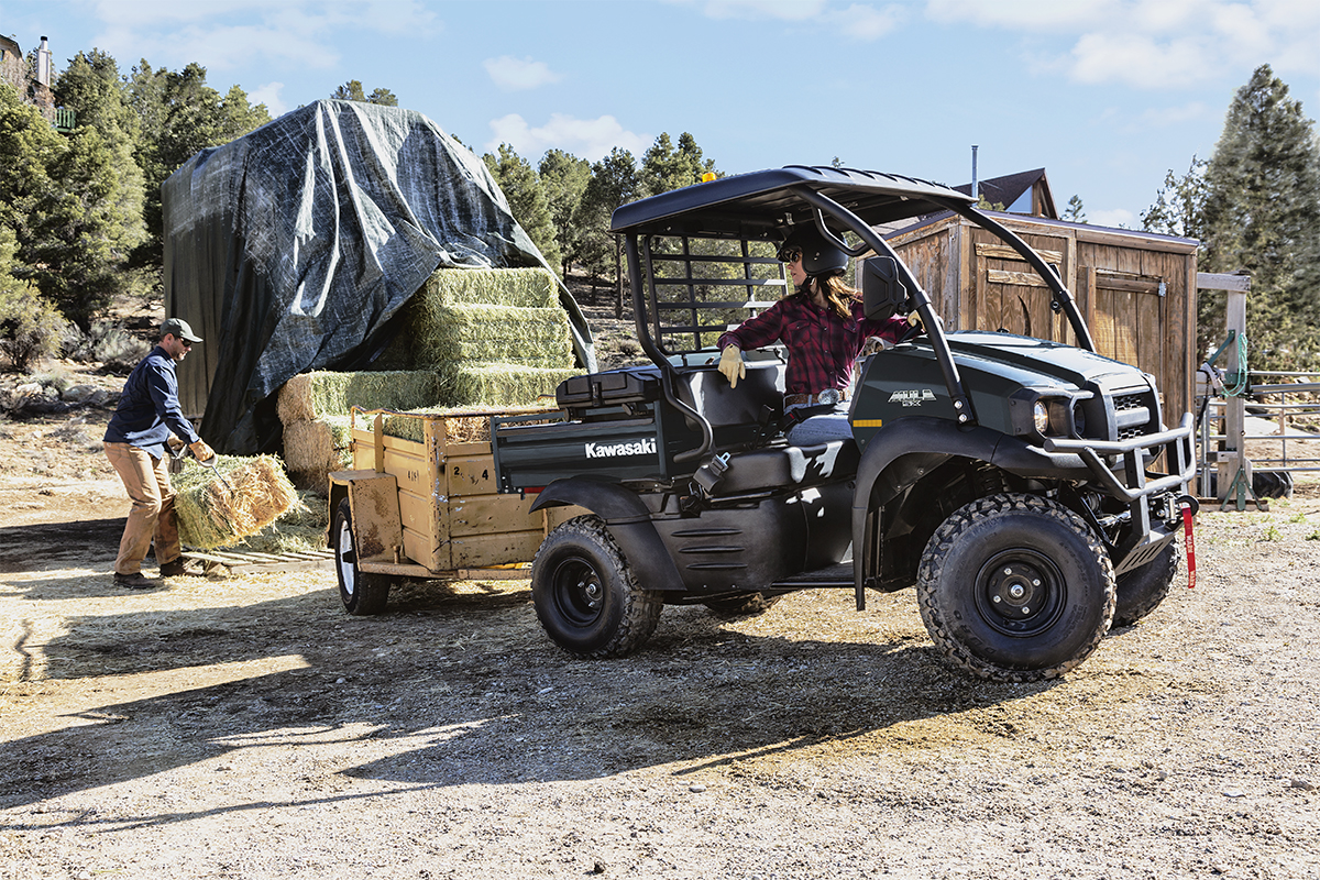 Profile angle of a person driving a side x side on a jobsite.