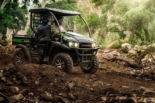 Profile angle of two people driving a side x side off-road. opens in a new window
