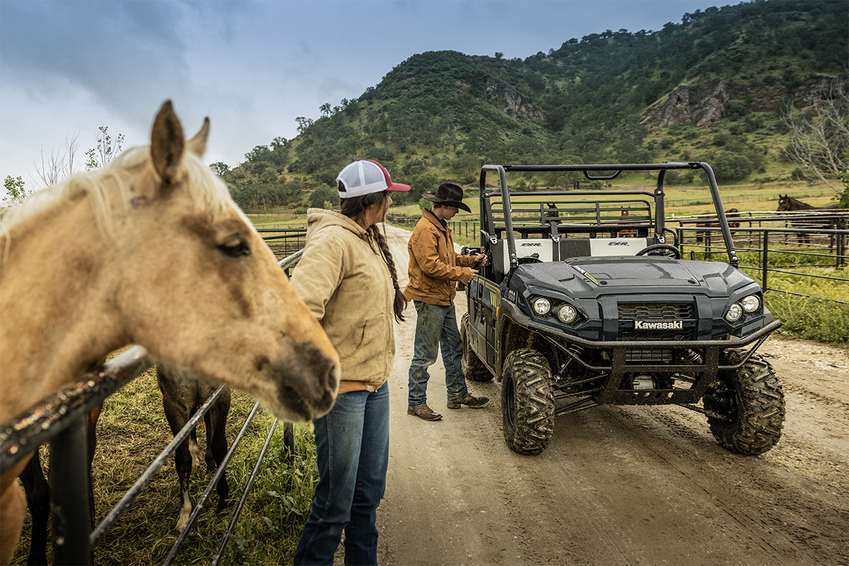 Front angle of a side x side parked on a ranch.