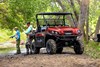 Three-quarter front angle of a side x side parked off-road.