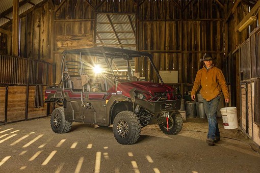 Three-quarter front angle of a side x side parked in a barn. opens in a new window