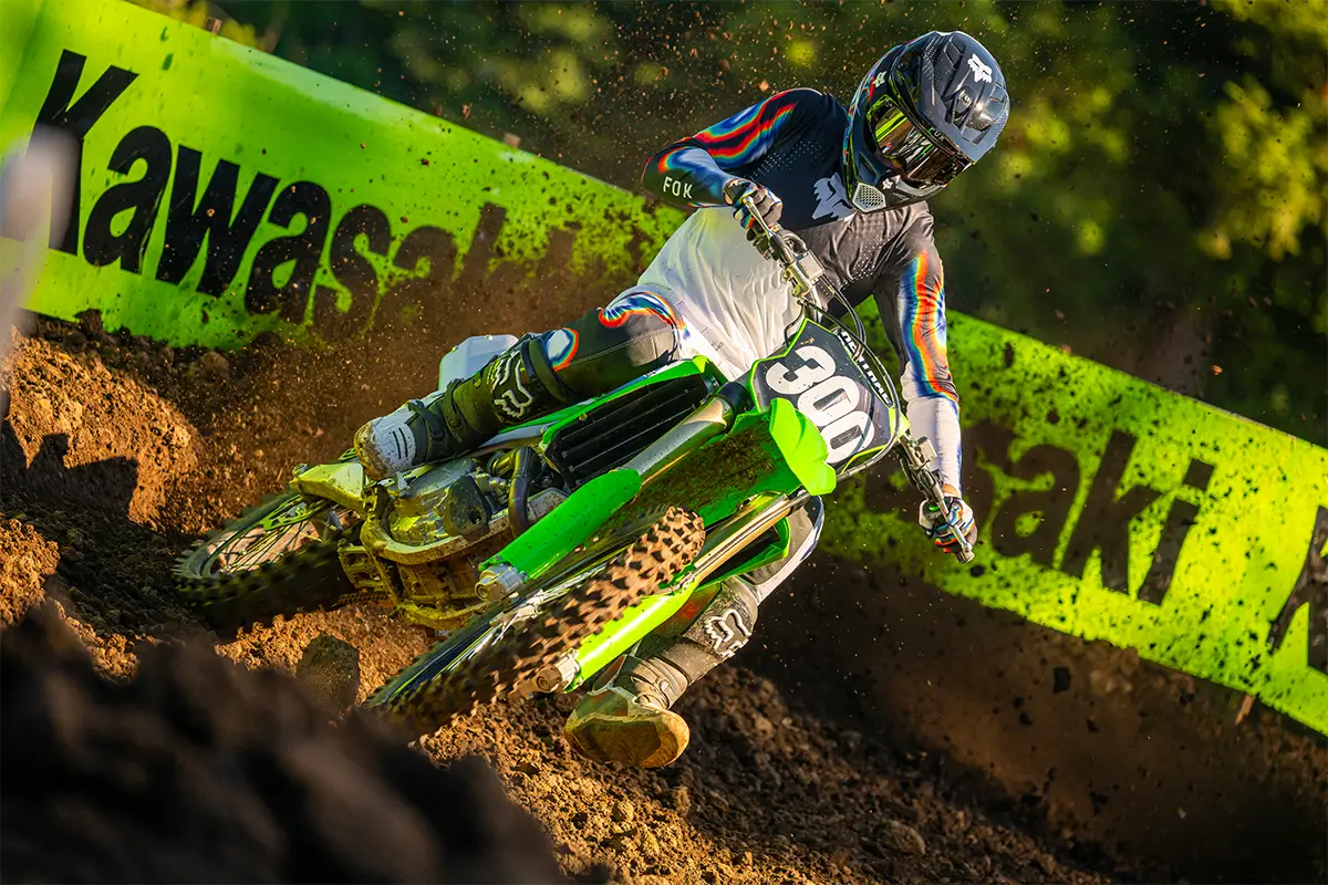 Front angle of a person riding a motorcycle on a dirt track.