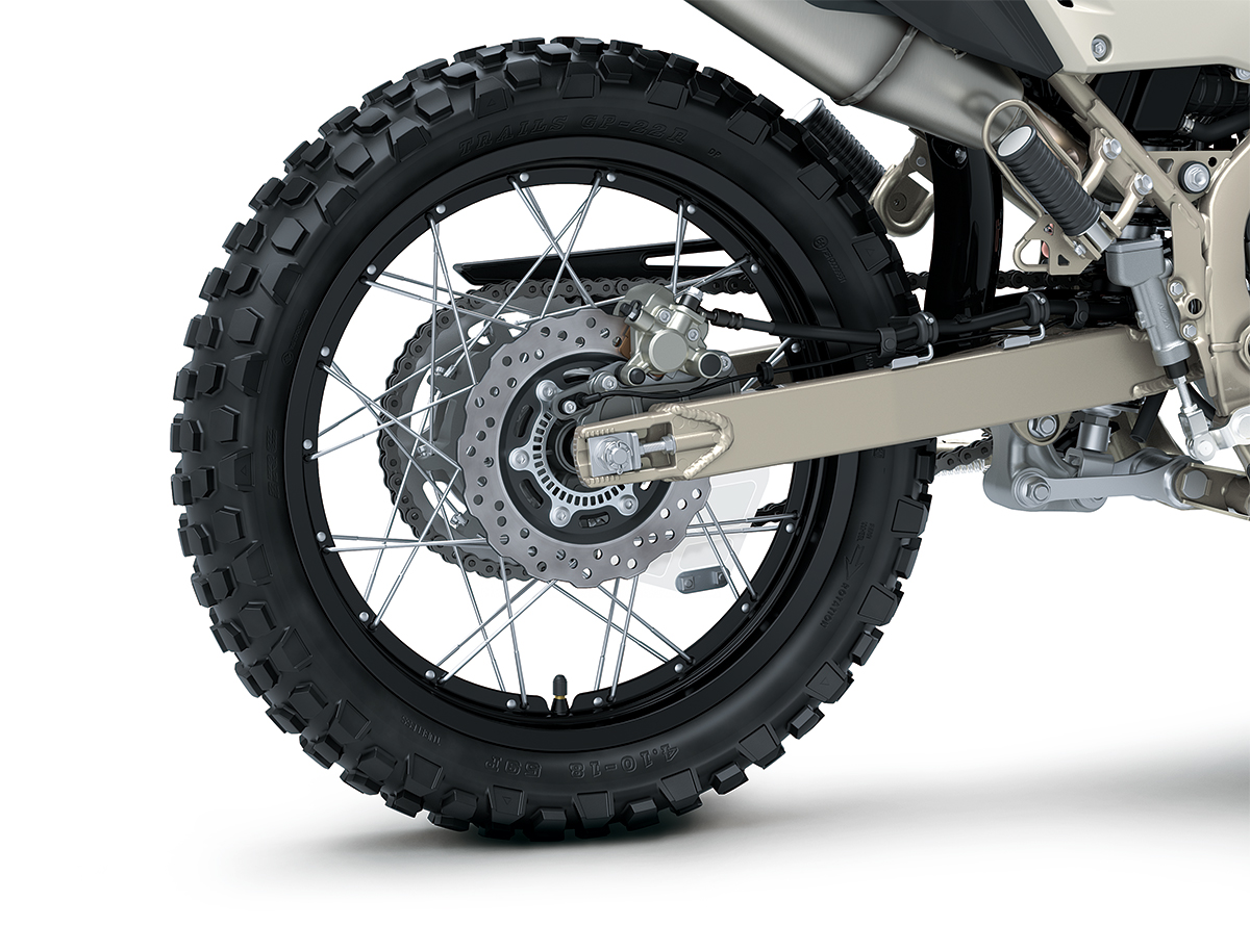 Close-up view of the rear tire of a motorcycle staged in a white studio background.