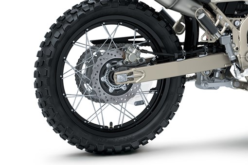 Close-up view of the rear tire of a motorcycle staged in a white studio background. opens in a new window