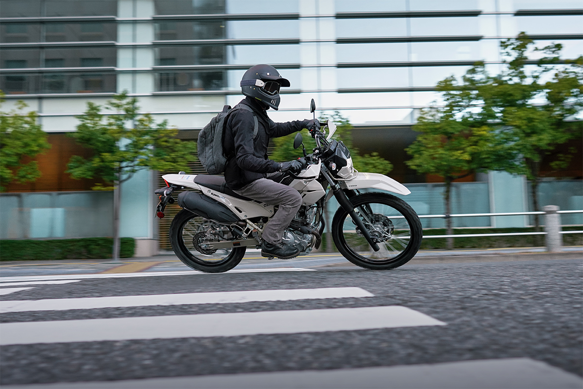 Side angle of a person riding a motorcycle on the highway.