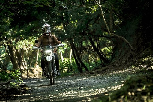 Front angle of a person riding a motorcycle off-road. opens in a new window