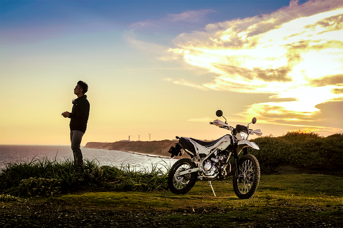 Three-quarter front angle of a motorcycle parked off-road.