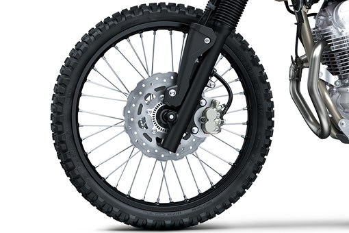 Close-up view of the front tire of a motorcycle staged in a white studio background. opens in a new window