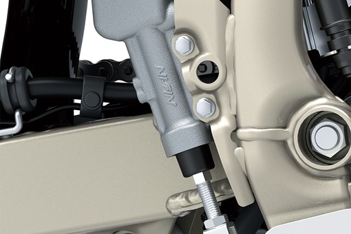 Close-up view of the master cylinder of a motorcycle staged in a white studio background. opens in a new window
