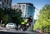 Front angle of a person riding a motorcycle on a city street.