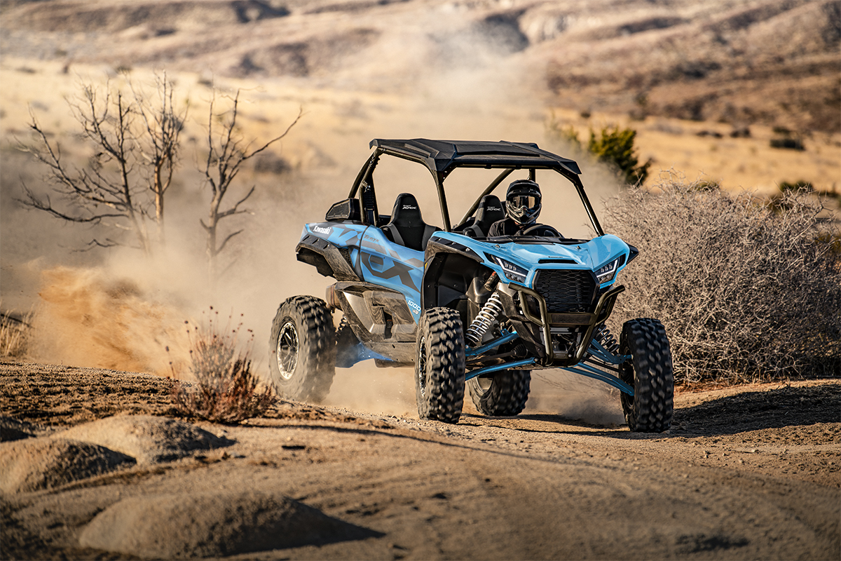 Three-quarter front angle of a person riding a sport side x side off-road.