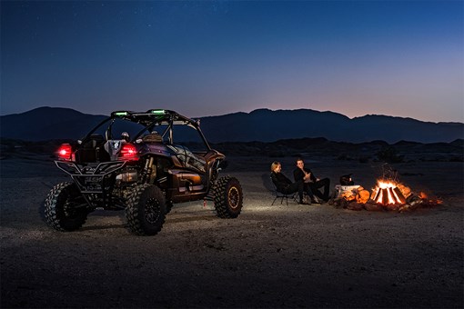 Three-quarter rear angle of a side x side parked off-road. opens in a new window
