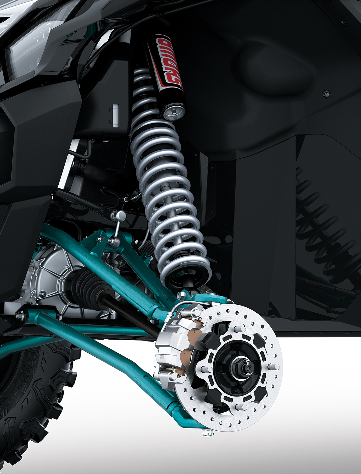 Close-up view of the front suspension and brake assembly of a side x side staged in a white studio background.