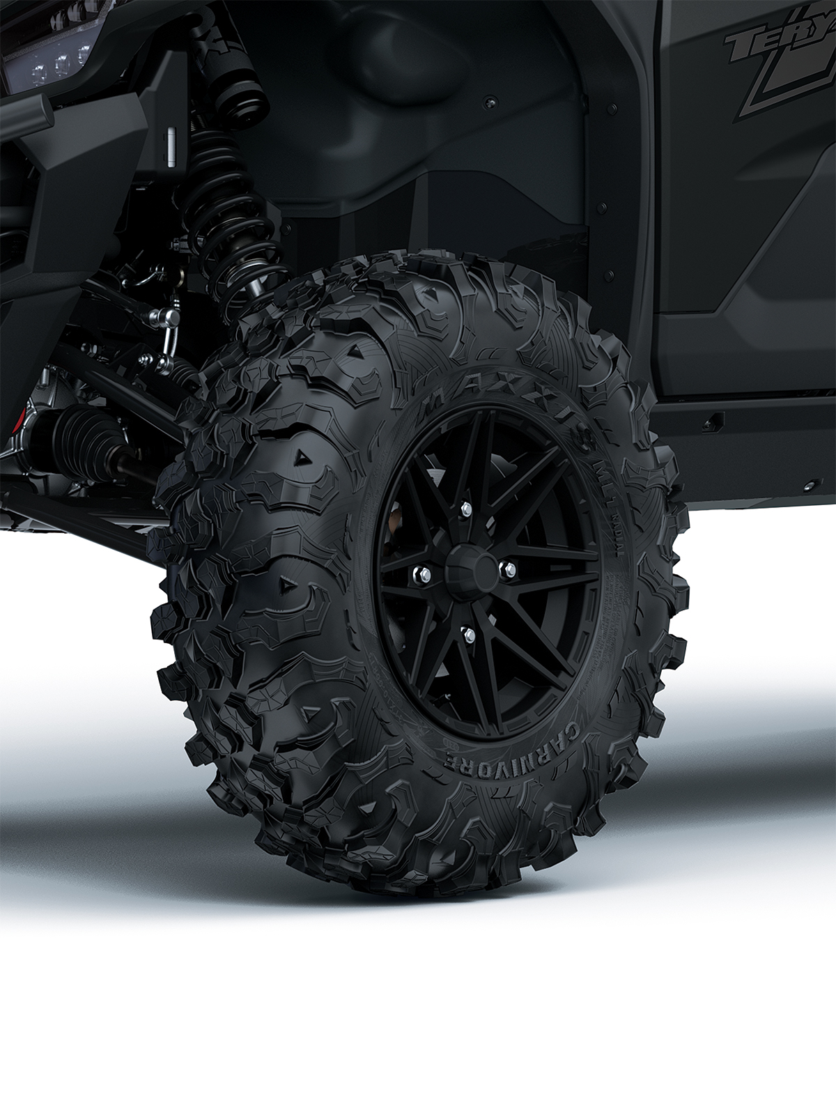 Close-up view of the front-left tire of a side x side staged in a white studio background.