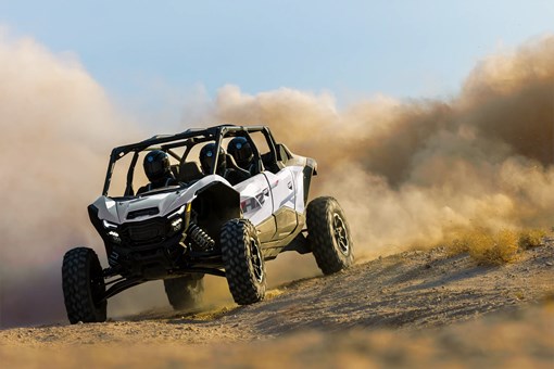 Front angle of a person driving a side x side. opens in a new window