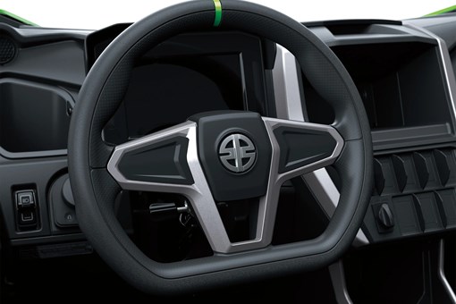 Close-up of a steering wheel on a side x side in a white studio background. opens in a new window
