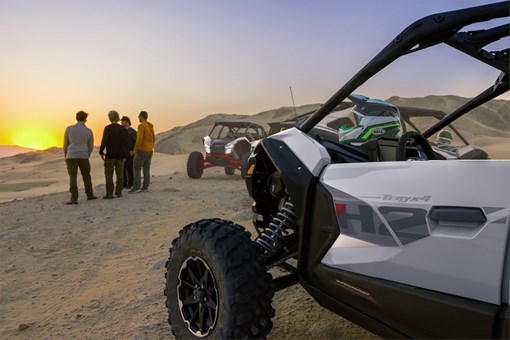 Close-up of the driver's side of a side x side parked on a hill. opens in a new window