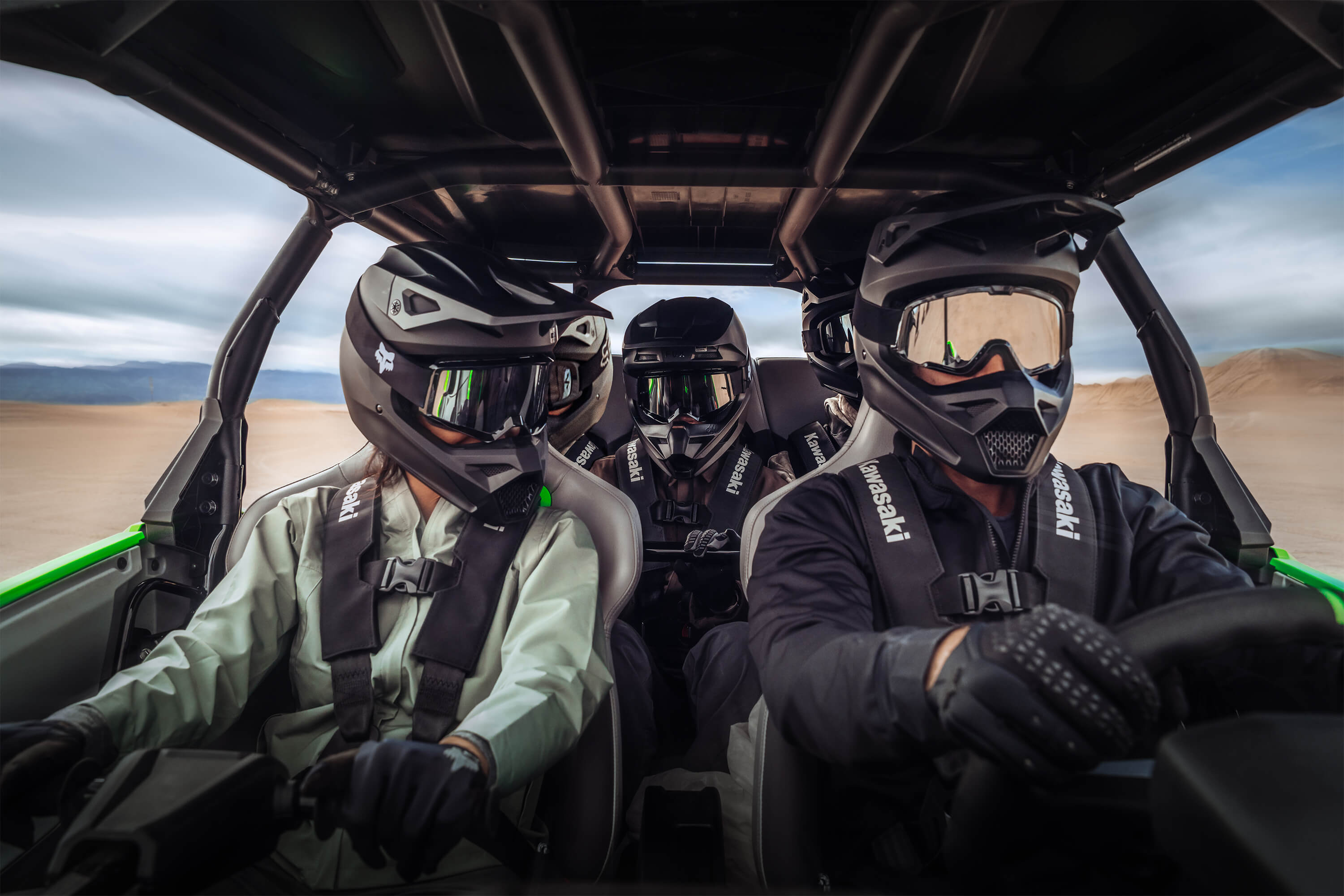 Inside a side x side with a driver and two passengers.