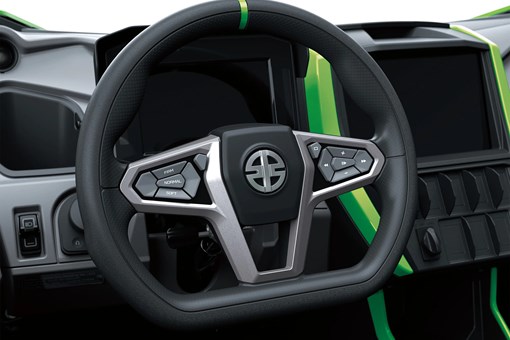 Close-up of a steering wheel on a side x side in a white studio background. opens in a new window