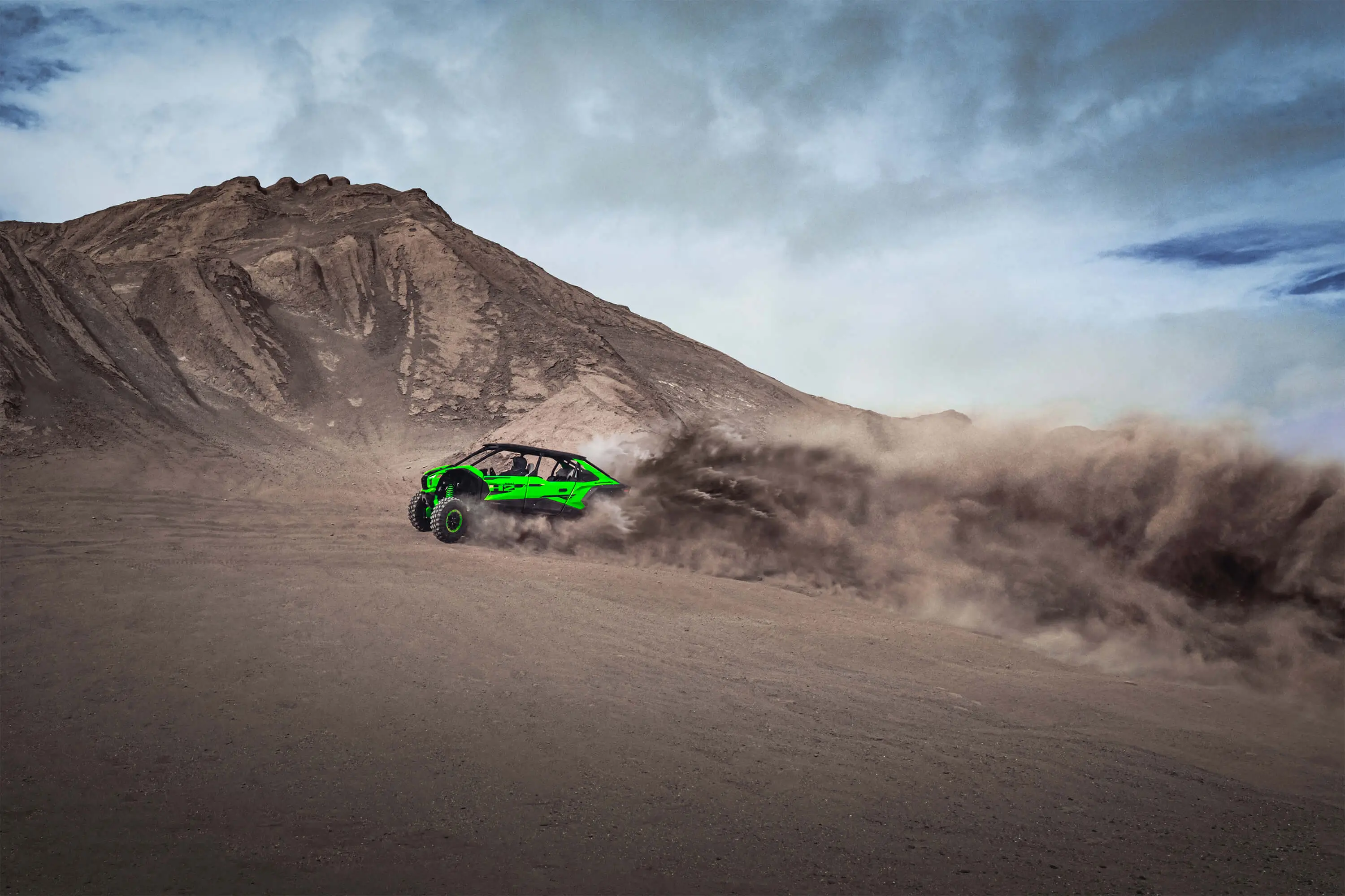 Side angle of a person driving a side x side off-road.