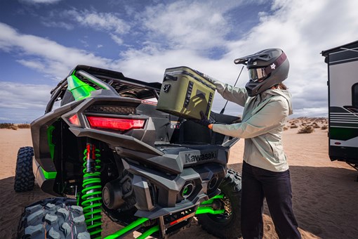 Person loading the back of a side x side off-road. opens in a new window