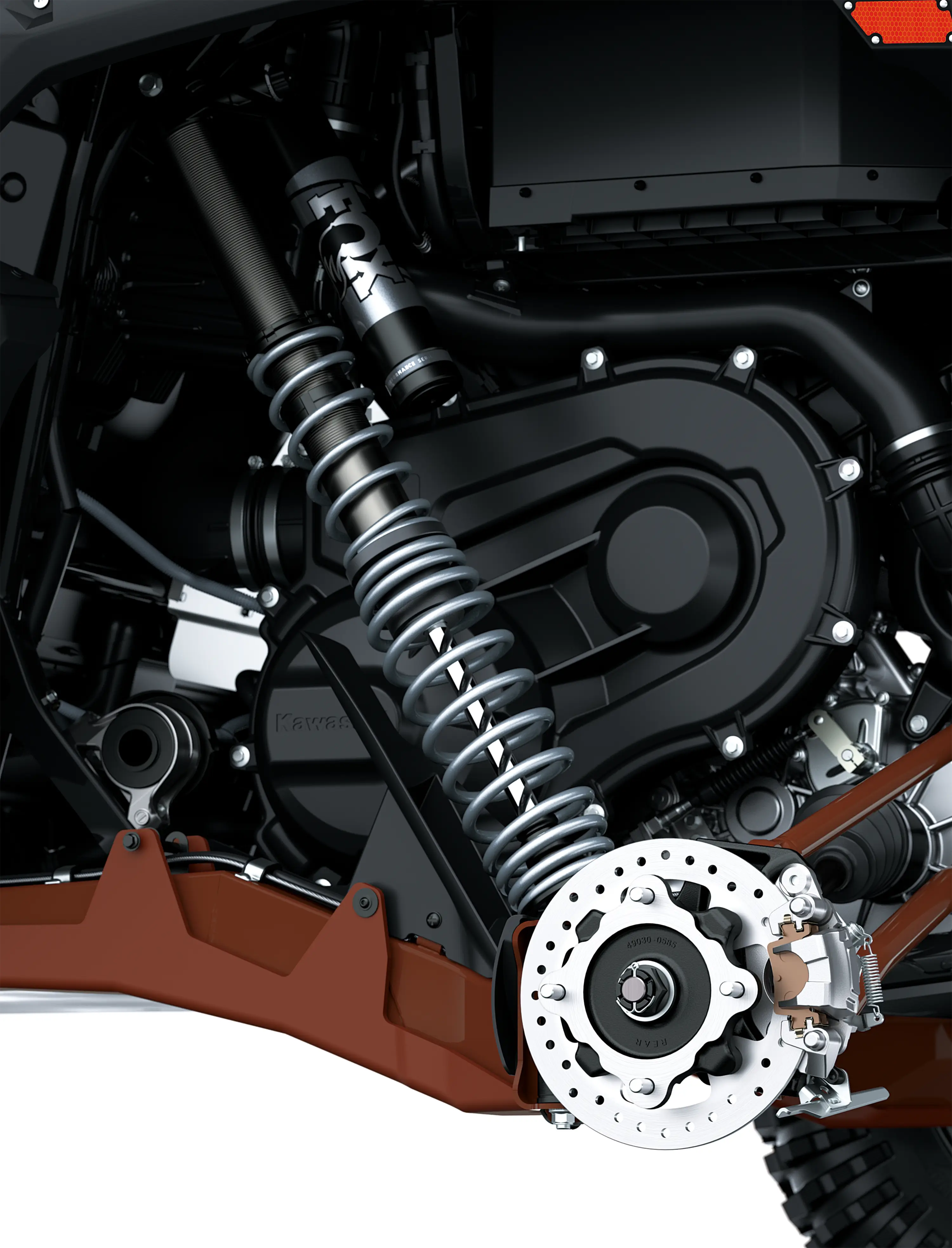 Close-up view of the suspension, brake system, and engine compartment of a side x side staged in a white studio background.