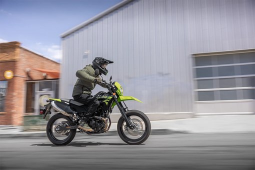 Side angle of a person riding a motorcycle on the street. opens in a new window