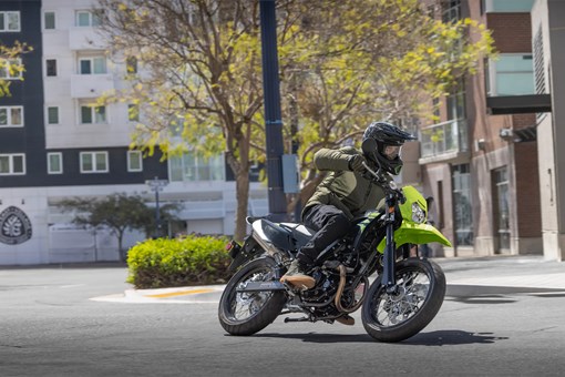 Profile angle of a person riding a motorcycle on a highway. opens in a new window