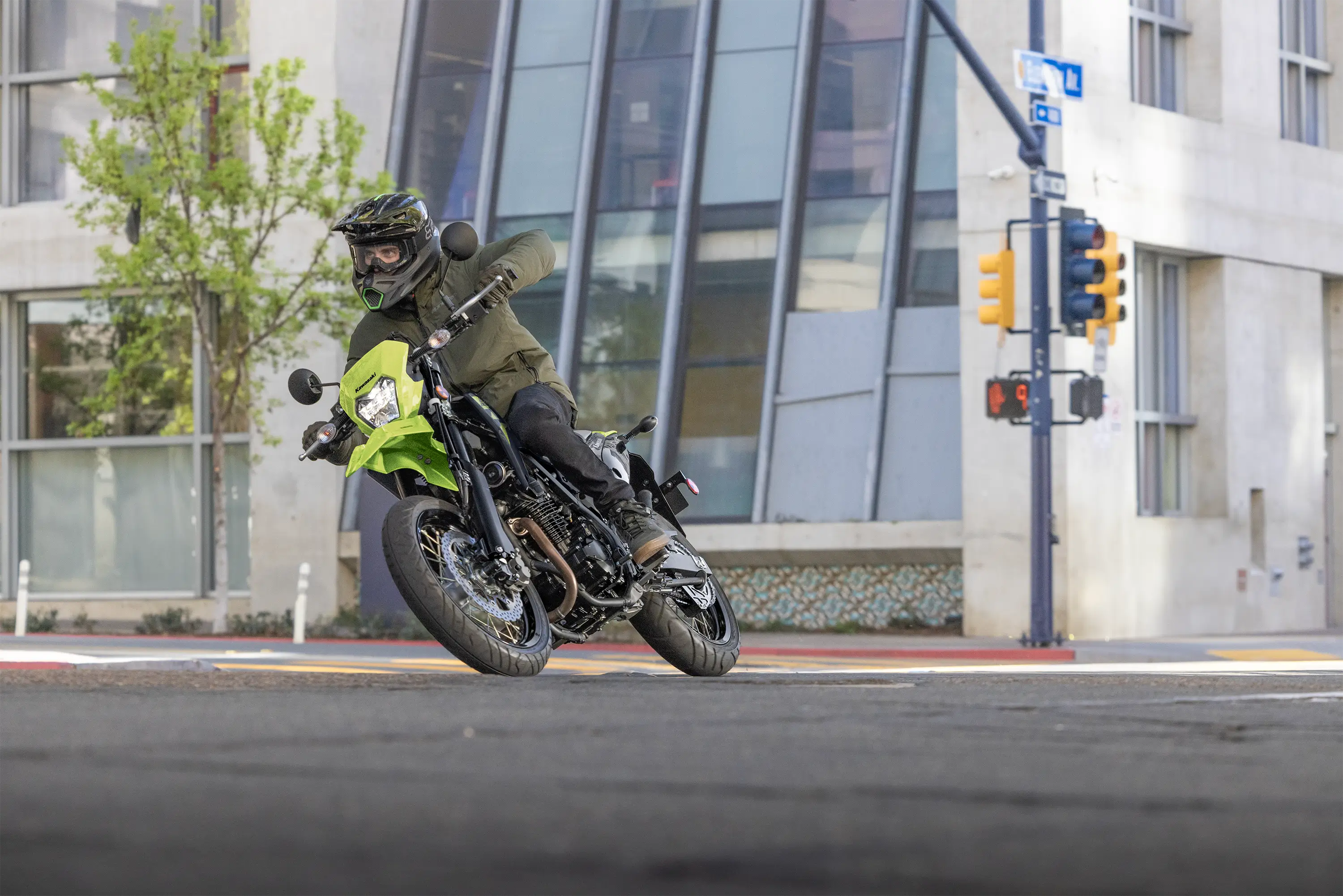 Three-quarter front angle of a person turning a motorcycle on the street.