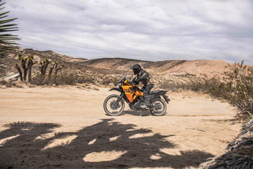Profile angle of a person riding a motorcycle off-road. opens in a new window