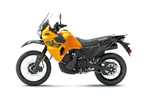 Profile angle of an orange motorcycle staged in a white studio background. opens in a new window