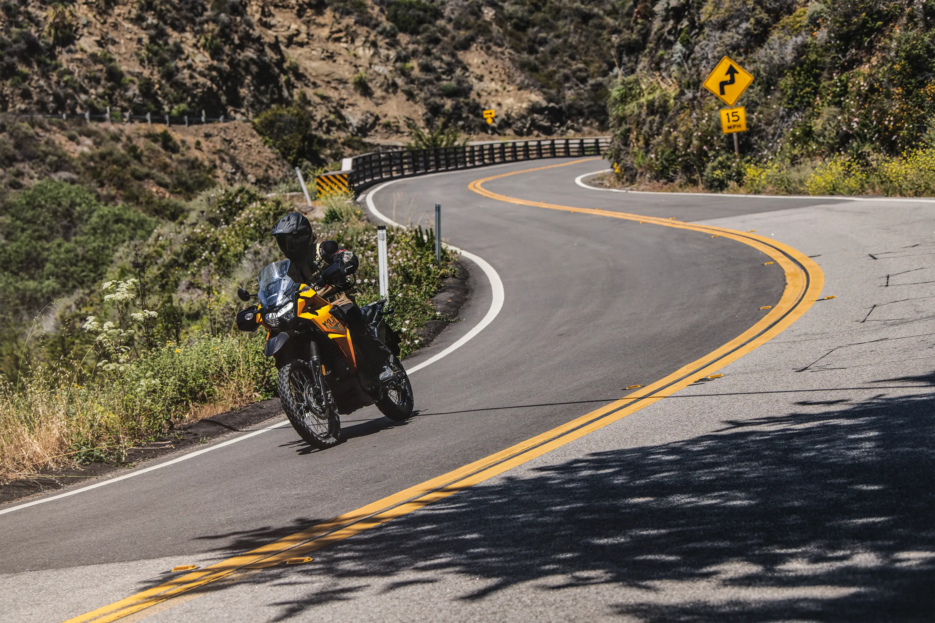 Front angle of a person riding a motorcycle on a highway.