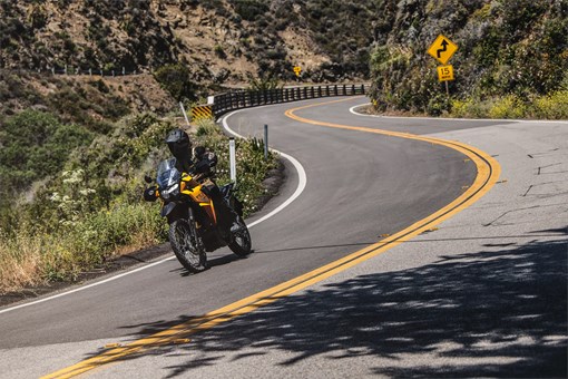 Front angle of a person riding a motorcycle on a highway. opens in a new window
