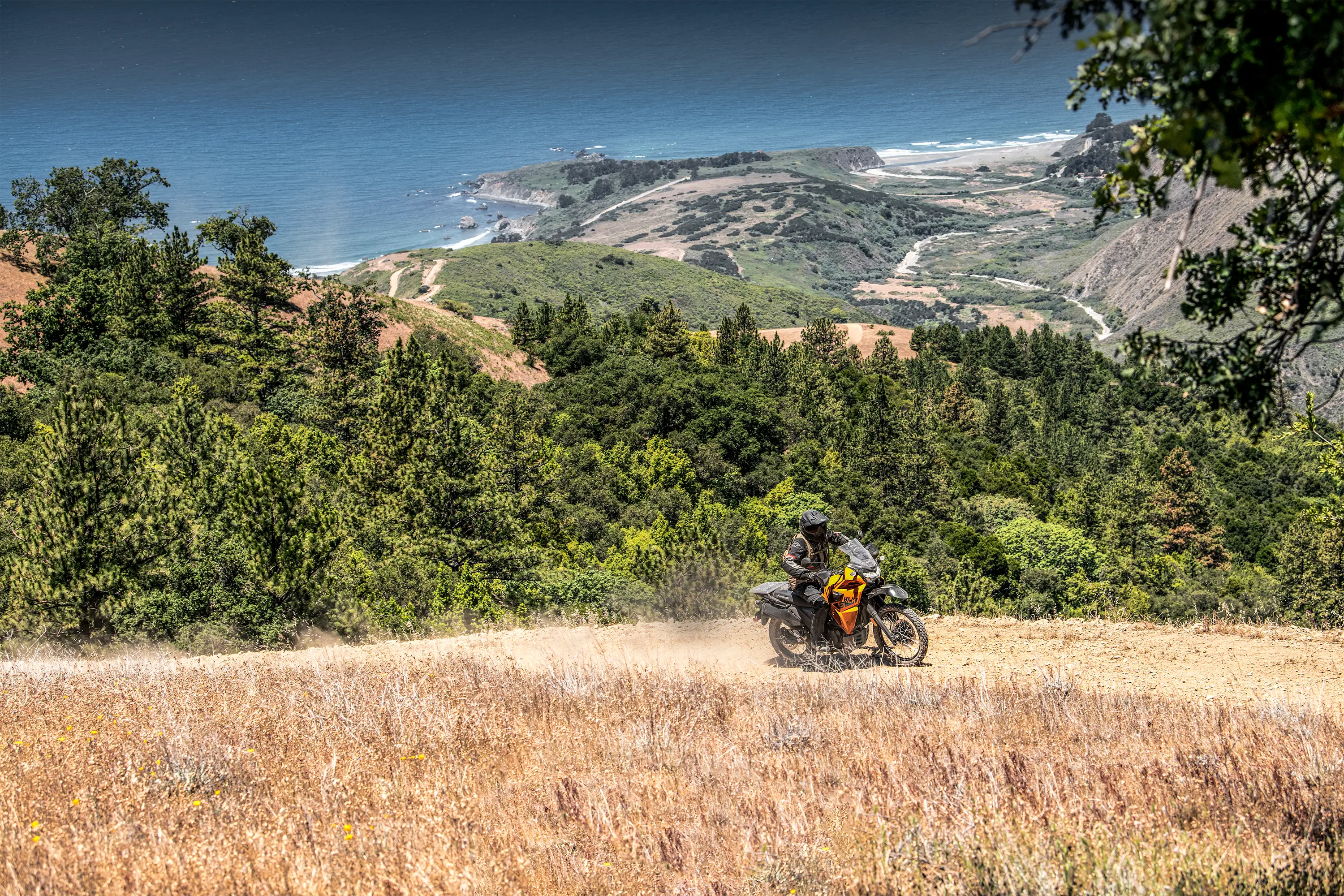 Side angle of a person riding a motorcycle off-road.