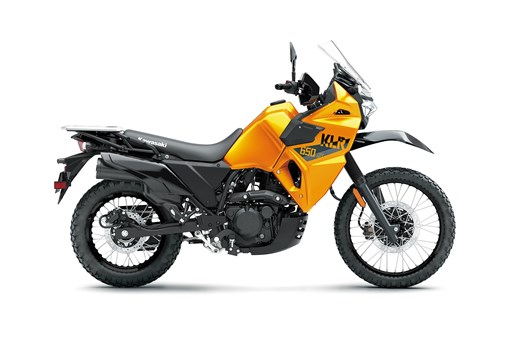 Side angle of an orange motorcycle staged in a white studio background. opens in a new window