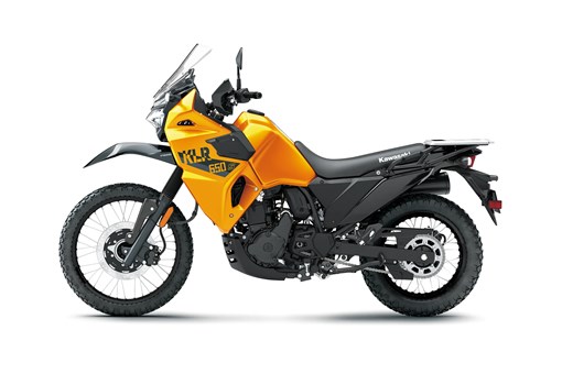 Profile angle of an orange motorcycle staged in a white studio background. opens in a new window