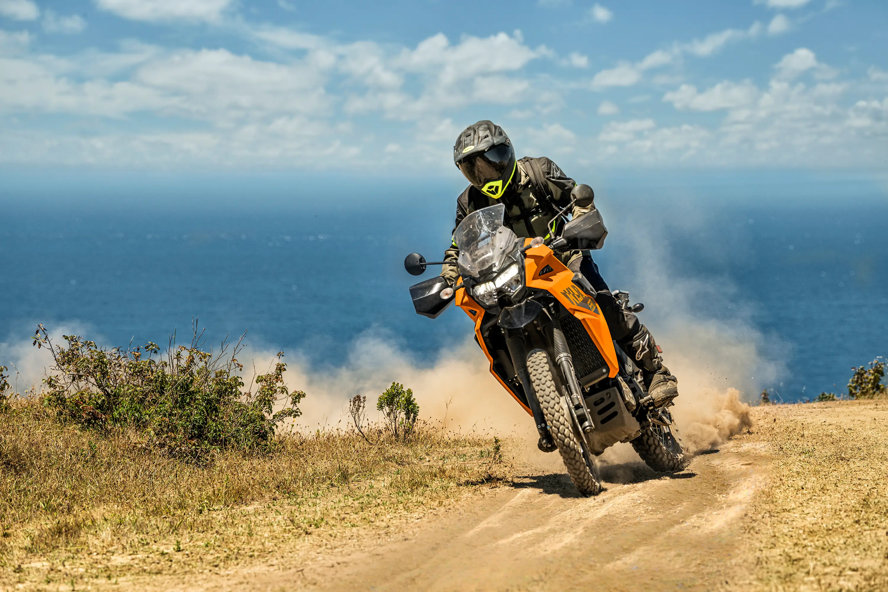 Three-quarter front angle of a person riding a motorcycle off-road.