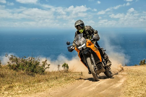 Three-quarter front angle of a person riding a motorcycle off-road. opens in a new window