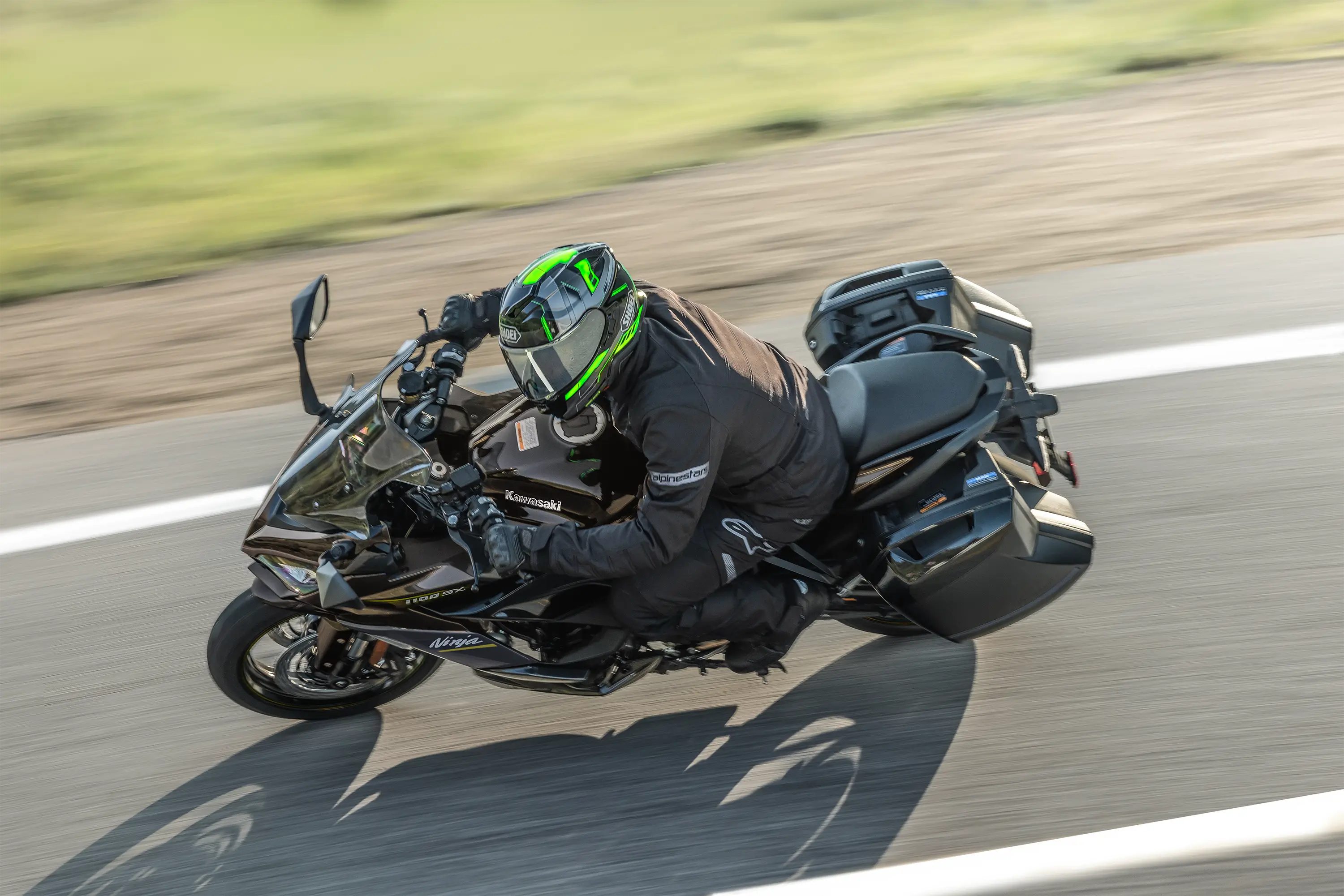 Overhead angle of a person riding a motorcycle on a highway.