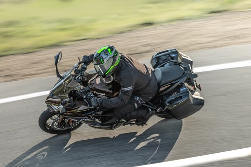 Overhead angle of a person riding a motorcycle on a highway. opens in a new window