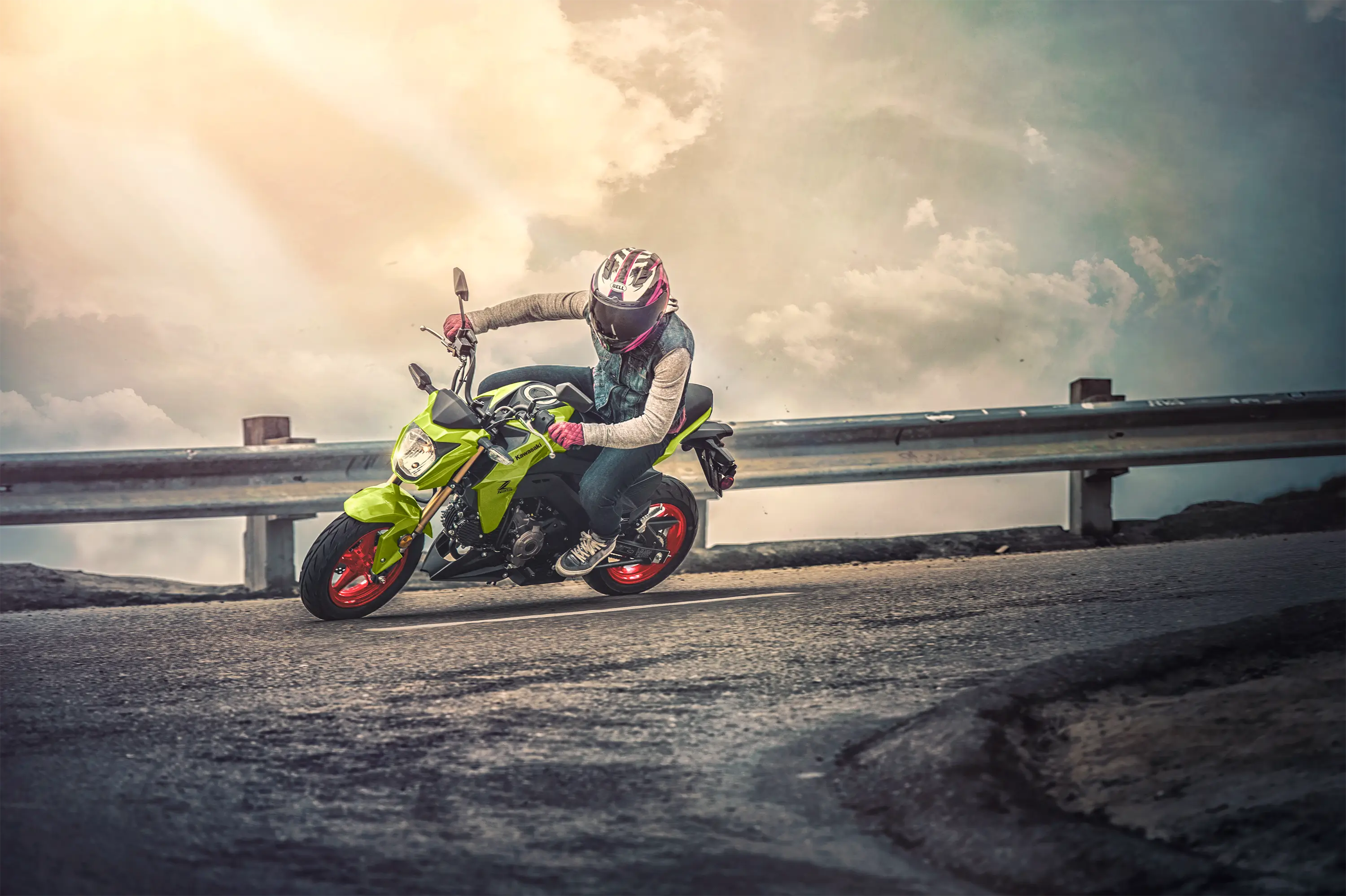 Side angle of a person riding a motorcycle on a highway.